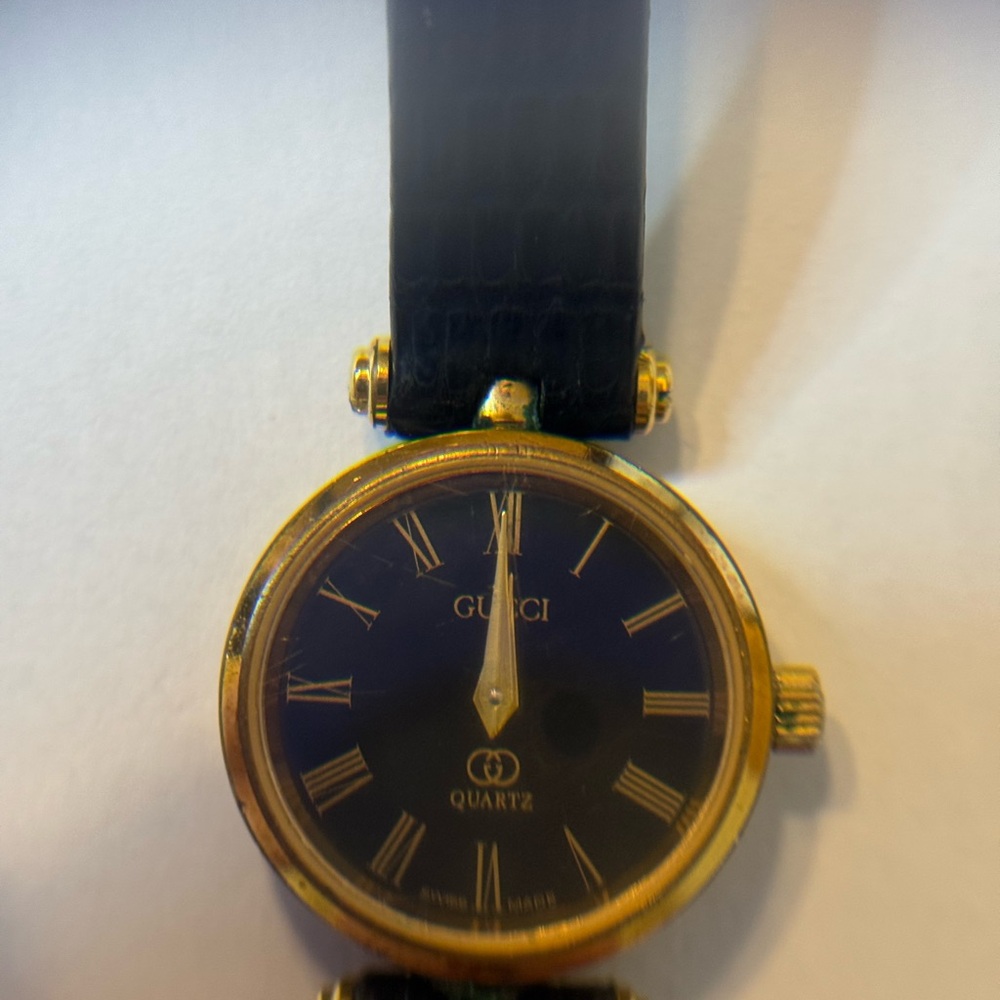 Gucci Black and Gold Roman Numeral Watch